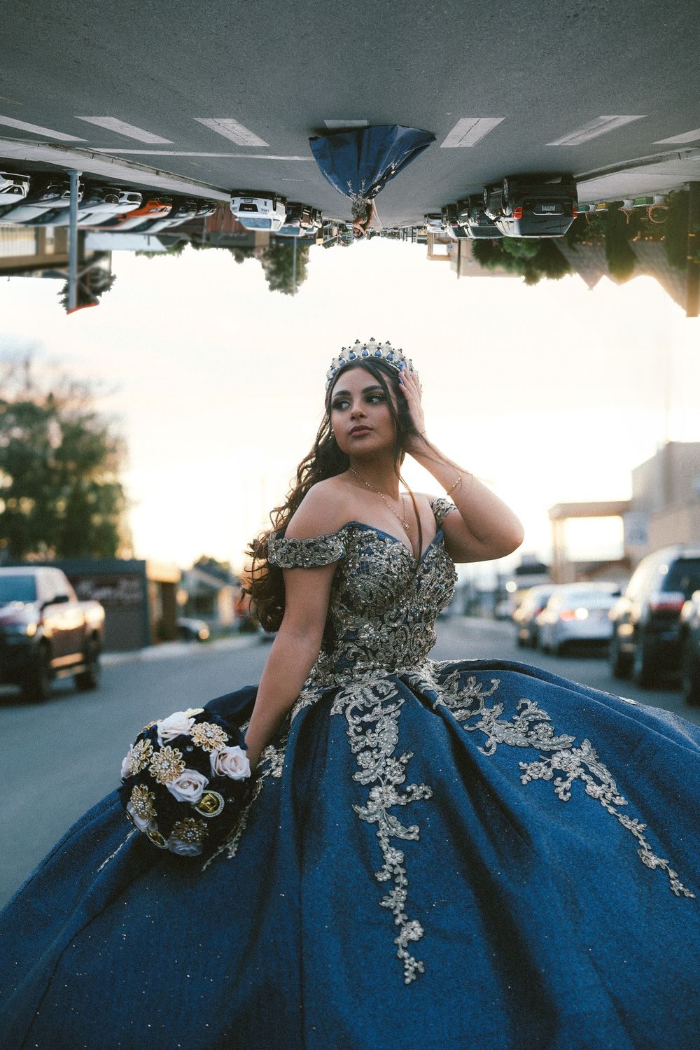 QuinceaƱera in a blue gown on a downtown street