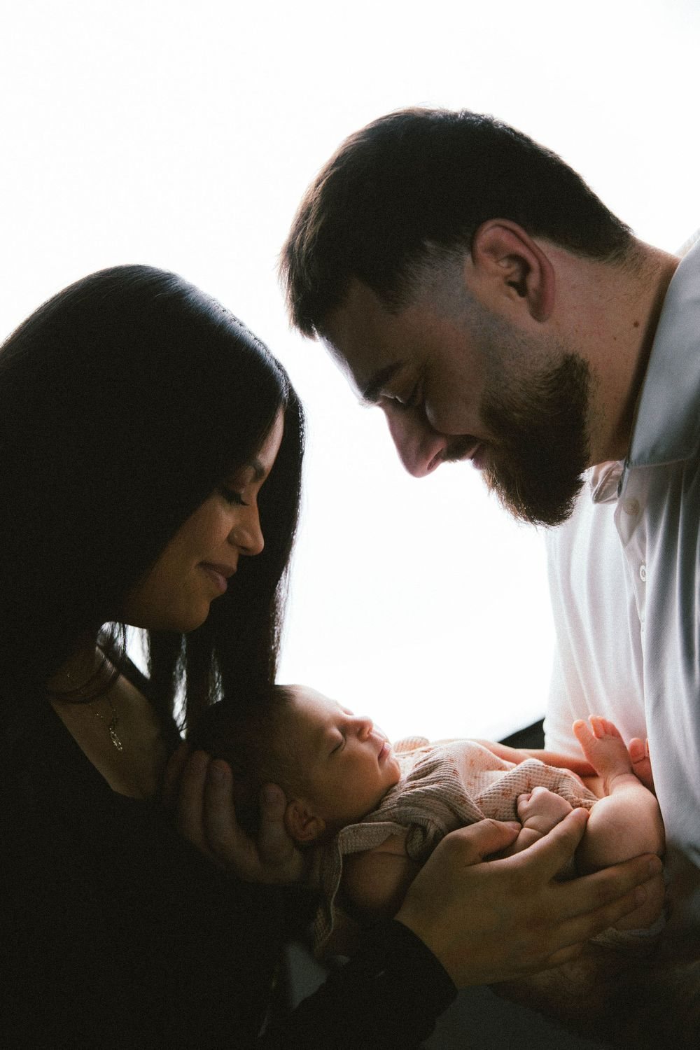Couple looking down at their newborn